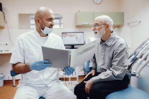 A professional dentist is explaining about teeth implantation
