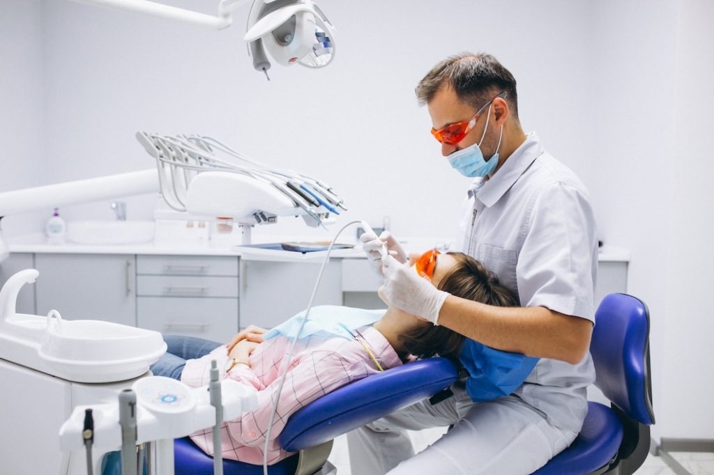 Woman patient at dentist consultation about dental implant treatment