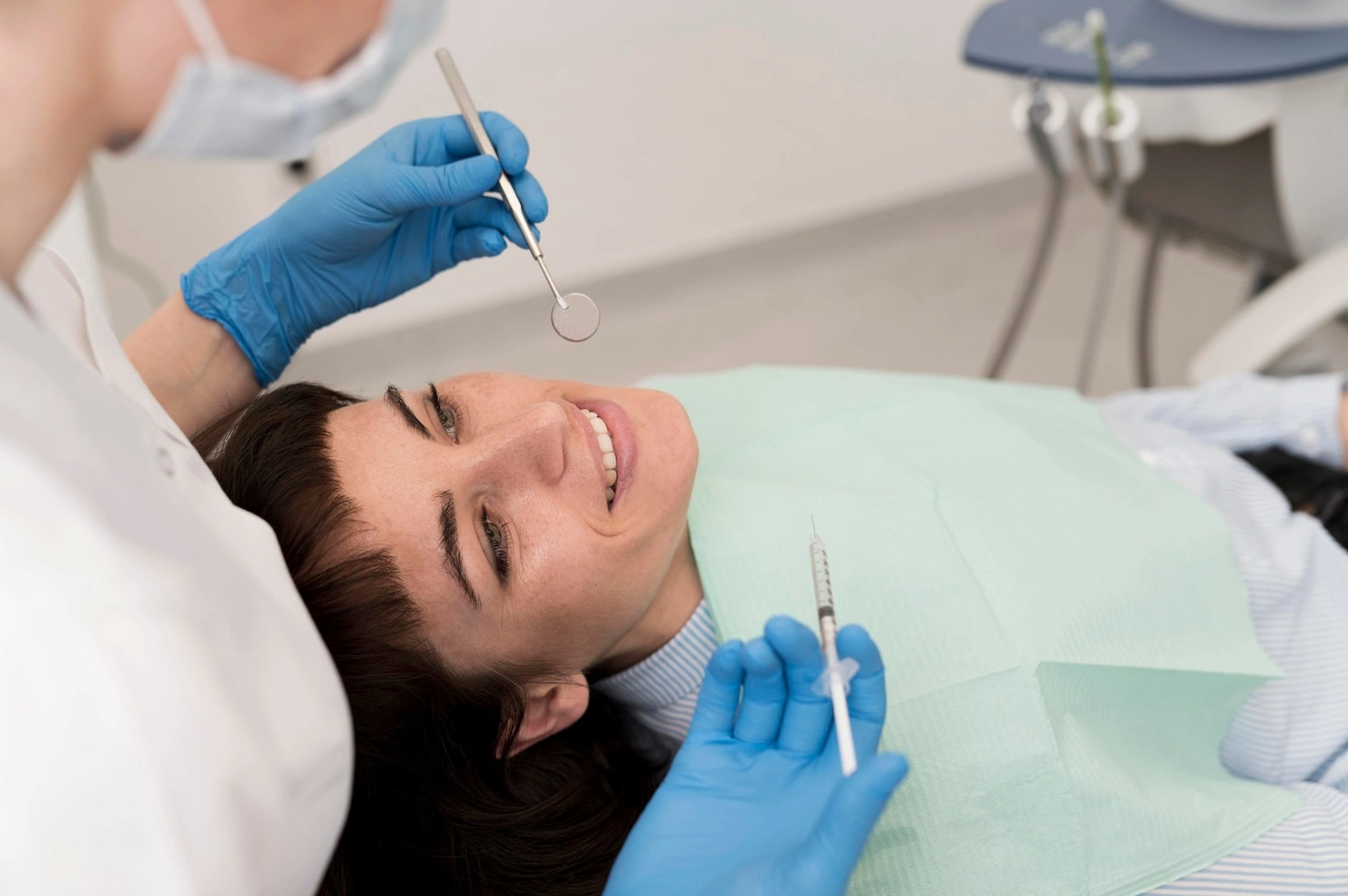 Female patient receiving single tooth implant procedure at dentist clinic